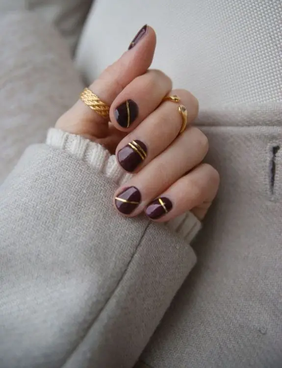gold stripes on maroon nails